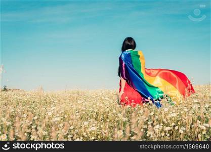 woman with lgbt flag on the field