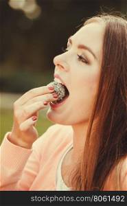 Woman with liitle cookie cupcake.. Food and sweets. Appetite and tasty meal dessert. Joyful woman with little cookie cupcake. Happy smiling girl eating small cake outdoor.