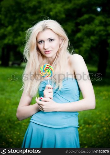 Woman With Lollipop On The Nature Background
