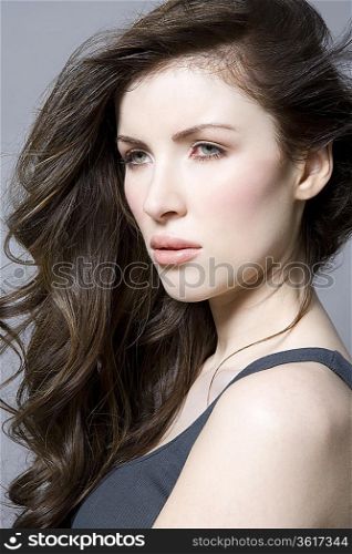 Woman with long brown wavy hair portrait