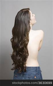 Woman with long brown wavy hair rear view