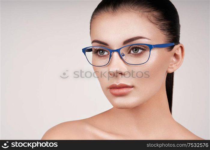 Woman with long eyelashes in eyeglasses. Vision correction. Poor eyesight. Spectacle frame. Makeup, cosmetics, beauty. Close up, macro