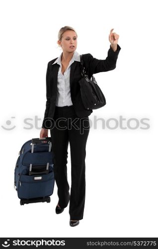 Woman with luggage hailing taxi