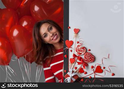Woman with magic wand, Valentines day. Woman with magic wand near Valentines day decoration and heart shaped lollipops isolated on white background