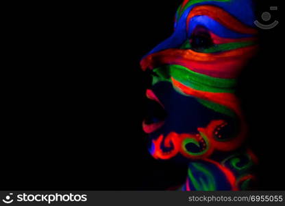 Woman with make up art of glowing UV fluorescent powder.