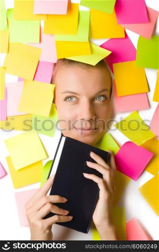 Woman with many reminder notes reading book