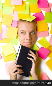 Woman with many reminder notes reading book