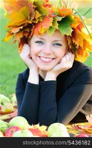 Woman with maple leaves outdoors. Close up face.