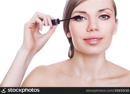 woman with mascara brush on white background