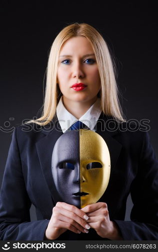 Woman with mask in hypocrisy concept