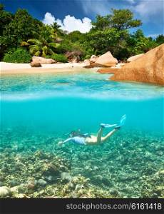 Woman with mask snorkeling in clear water at Seychelles