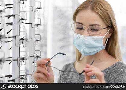 woman with mask store trying glasses 3. woman with mask store trying glasses 2