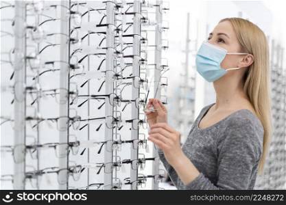 woman with mask store trying glasses 4. woman with mask store trying glasses 3