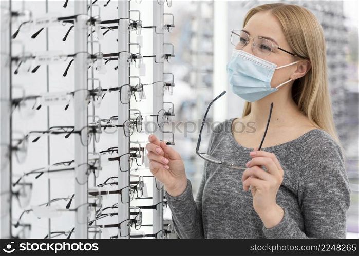 woman with mask store trying glasses 5. woman with mask store trying glasses 4
