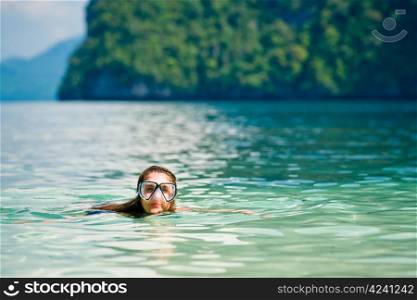 Woman with mask swimming in the sea