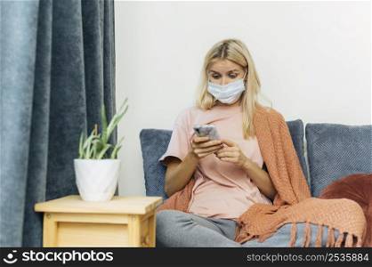 woman with medical mask smartphone home during pandemic