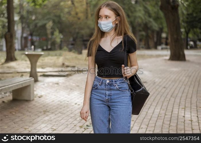 woman with medical mask walking park