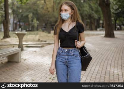 woman with medical mask walking park