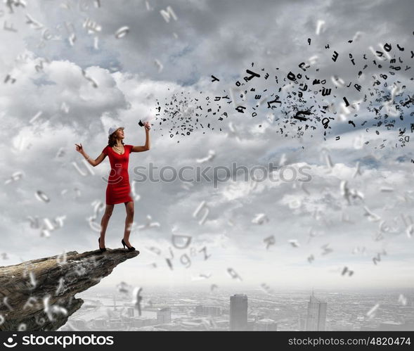 Woman with megaphone. Pretty woman in red dress screaming in megaphone