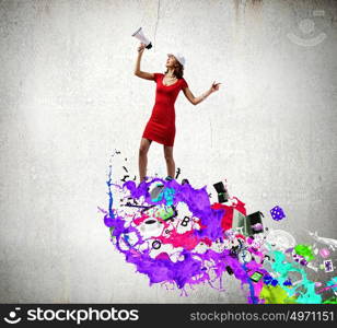 Woman with megaphone. Pretty woman in red dress screaming in megaphone