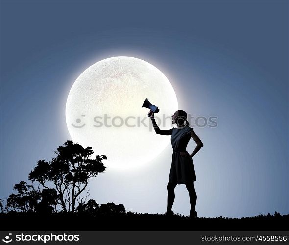 Woman with megaphone. Silhouette of woman at night screaming in megaphone