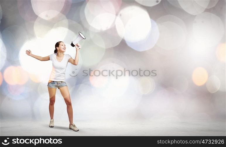 Woman with megaphone. Young woman in casual talking in megaphone