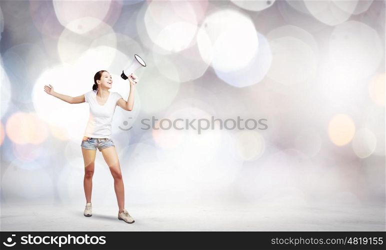 Woman with megaphone. Young woman in casual talking in megaphone