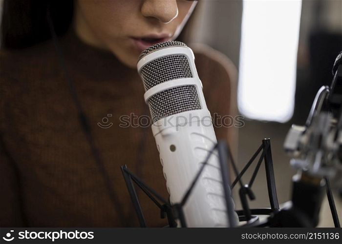 woman with microphone doing radio show