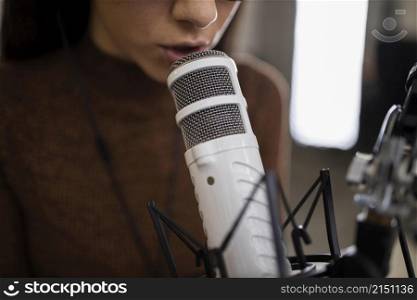 woman with microphone doing radio show