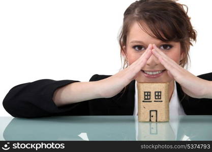 Woman with miniature model house