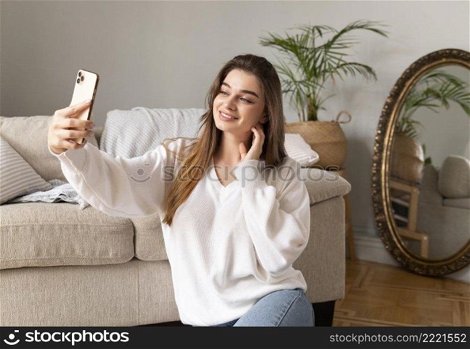 woman with mobile taking selfie