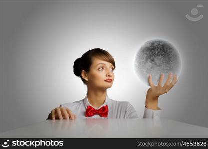 Woman with moon. Young woman holding moon planet in palm