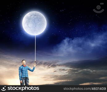 Woman with moon. Young woman in casual holding moon on lace