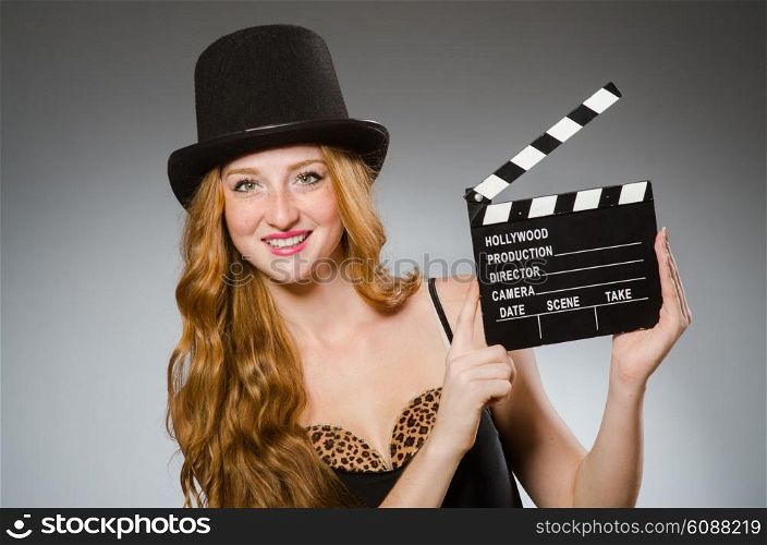 Woman with movie board wearing hat