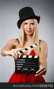 Woman with movie board wearing vintage hat