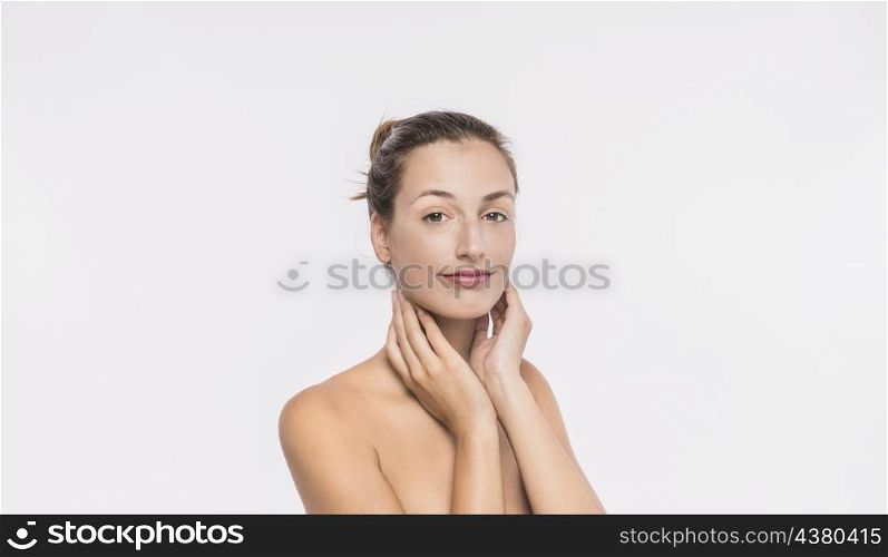 woman with naked shoulders touching neck