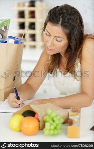 woman with notebook at home
