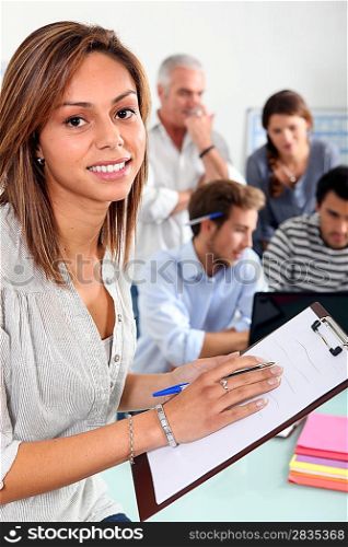 woman with notepad in classroom