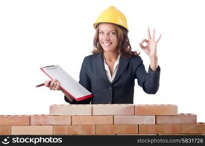 Woman with notepad on brick wall