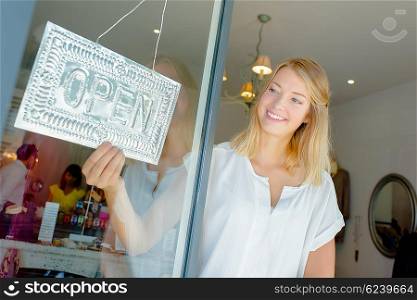 Woman with open shop sign