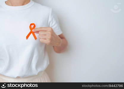 woman with Orange Ribbon for Leukemia, Kidney cancer day, world Multiple Sclerosis, CRPS, Self Injury Awareness month. Healthcare and word cancer day concept