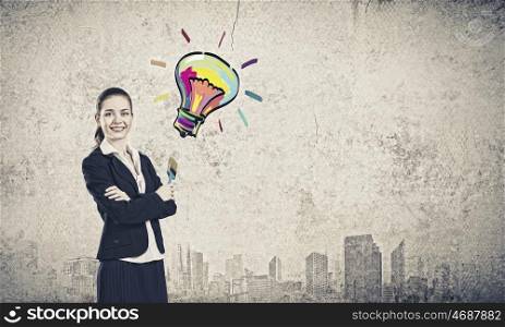 Woman with paint brush. Young pretty businesswoman holding paint brush. Creativity concept