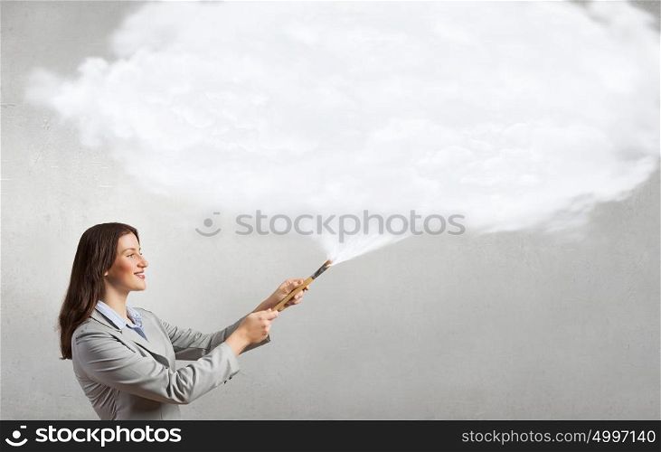 Woman with paint brush. Young pretty businesswoman holding paint brush. Creativity concept