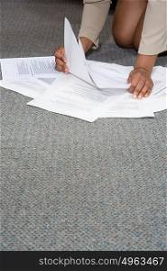 Woman with paperwork on the floor
