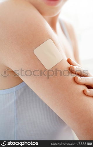 Woman with Patch on Arm