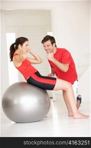Woman with personal trainer in home gym