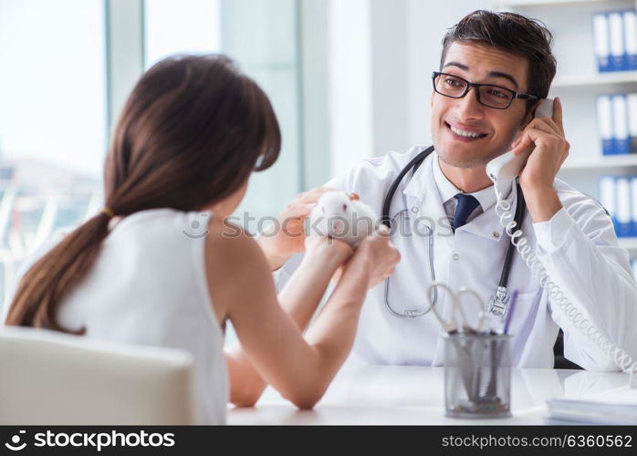 Woman with pet rabbit visiting vet doctor. The woman with pet rabbit visiting vet doctor