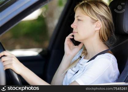 woman with phone in car