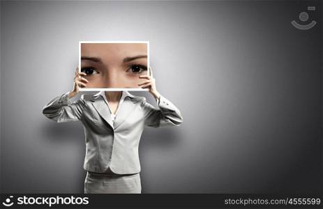 Woman with photo. Businesswoman hiding face behind photo of eyes