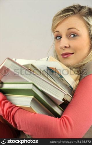 Woman with pile of books